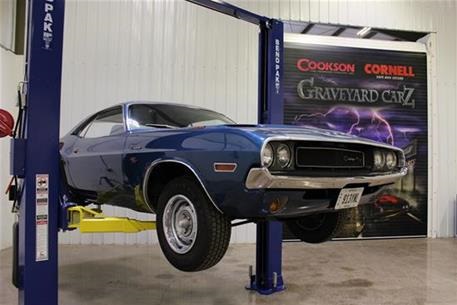 Picture of a car and rolling door at Graveyard Carz